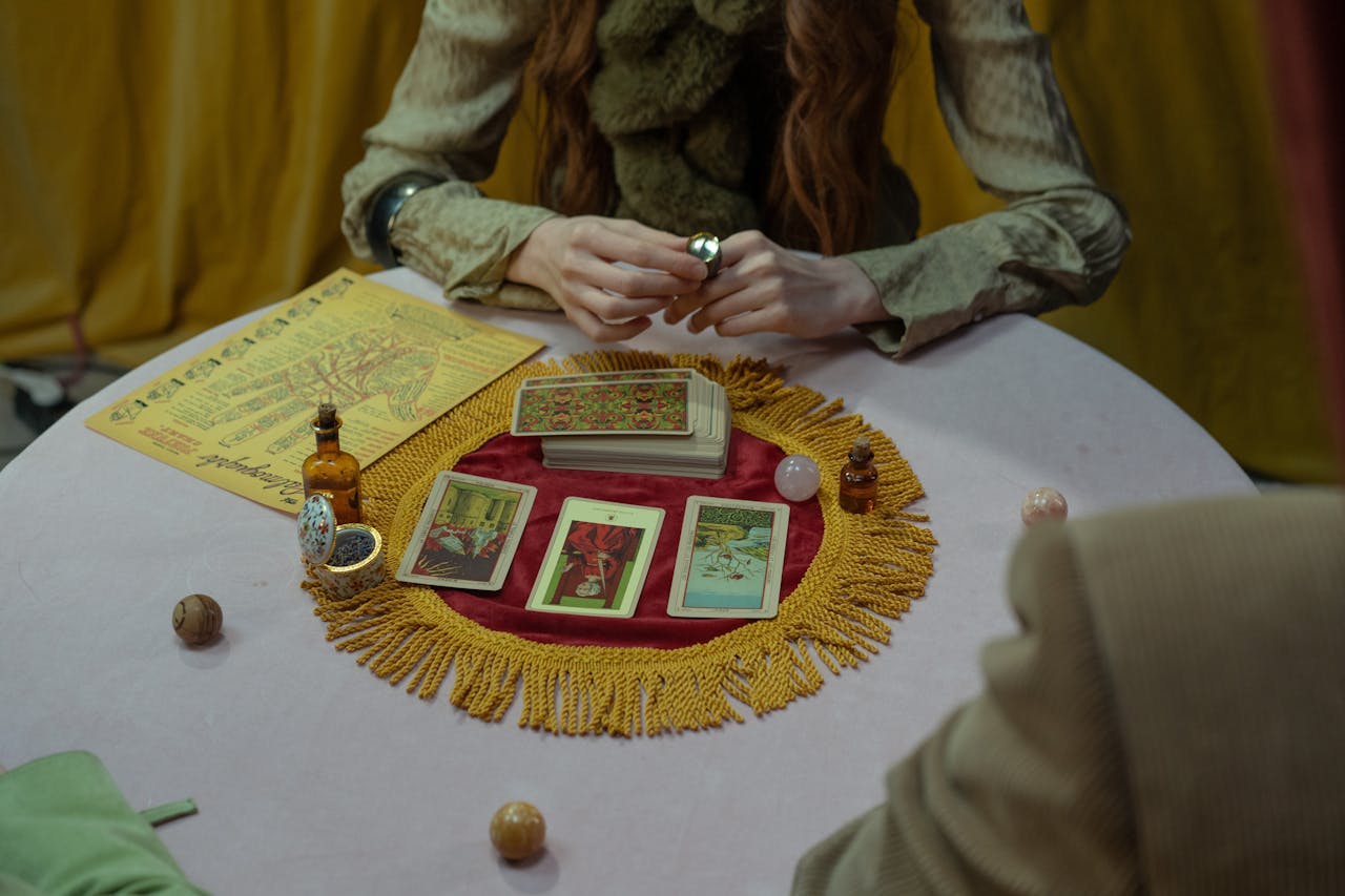 Mysterious tarot card reading setup with a fortune teller inside a cozy room setting.